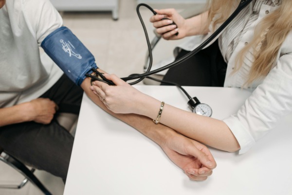 Doctor performing blood pressure test.