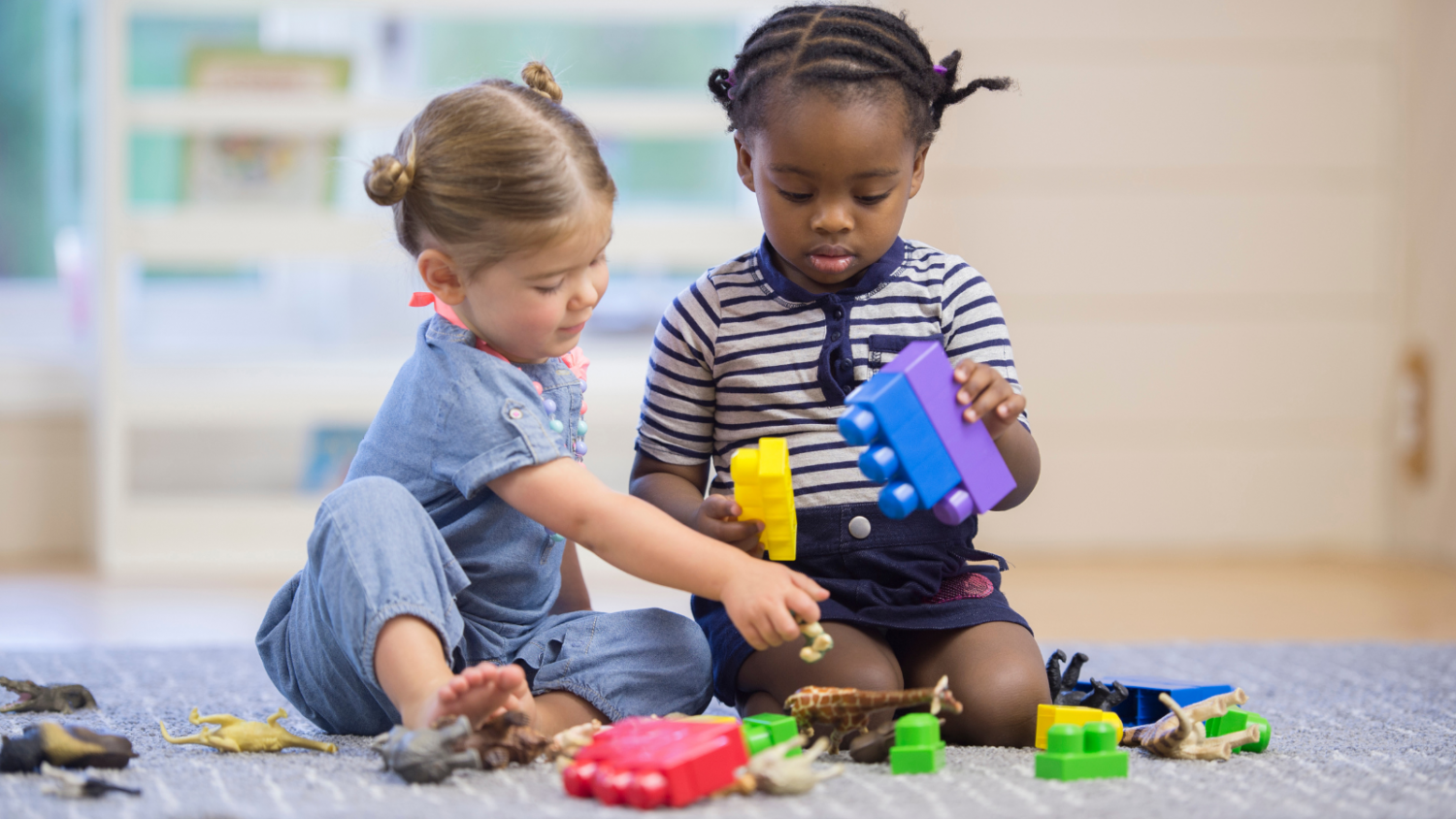 Two young children playing with toys